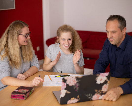 Parents helping their child with homework.